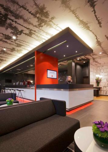 a lobby with a couch and a counter in a building at ibis London Shepherds Bush - Hammersmith in London