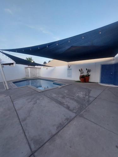 a building with a blue awning over a swimming pool at Amplia residencia con acceso privado in La Paz