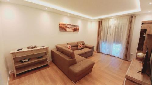 a living room with a couch and a table at La Terrazza in Tivat