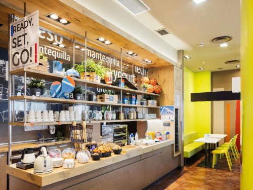 a restaurant with a counter with food on it at Ibis Budget Sevilla Aeropuerto in Seville