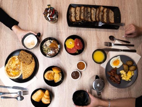 a table topped with plates of breakfast foods and drinks at Mercure Paris Bastille Marais in Paris