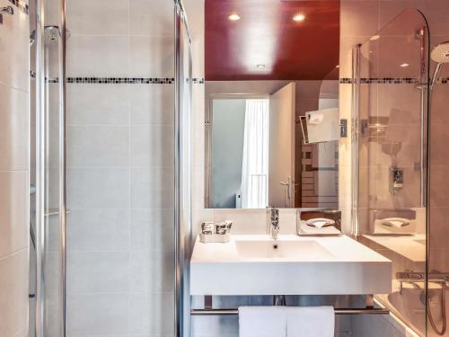 a bathroom with a sink and a shower at Mercure Paris Bastille Marais in Paris