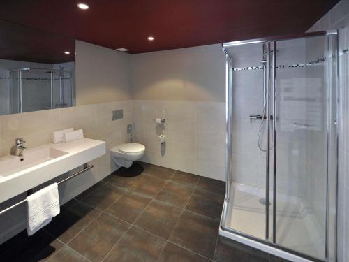 a bathroom with a shower and a sink and a toilet at Mercure Paris Bastille Marais in Paris
