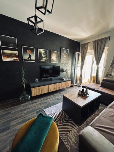 a living room with a couch and a table at Apartman Viktorija in Žabljak