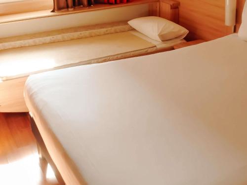 a close up of a bed in a room at ibis Santiago Providencia in Santiago