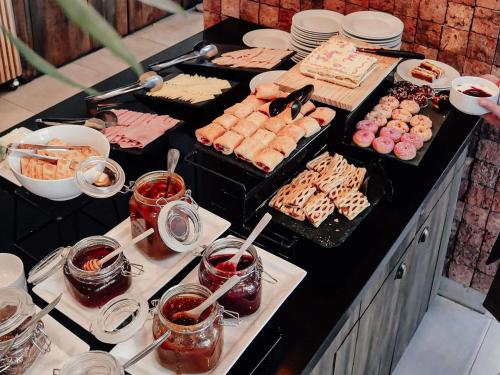 a buffet with many different types of food on a table at ibis Santiago Providencia in Santiago