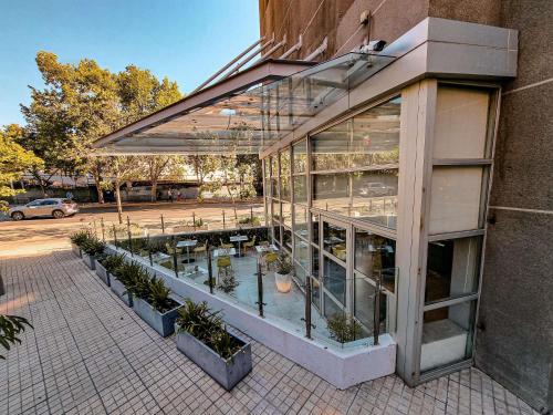 a glass building with plants inside of it at ibis Santiago Providencia in Santiago
