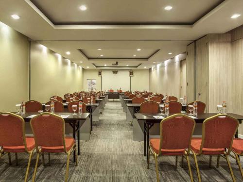 a conference room with tables and chairs in it at Ibis Surabaya City Center in Surabaya