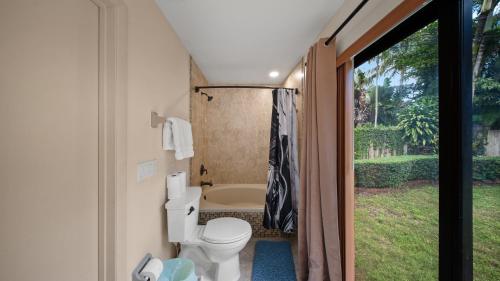a bathroom with a toilet and a bath tub at Private Entrance King Room and Private Bath UMiami in Miami
