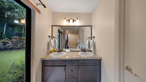 a bathroom with two sinks and a large mirror at Private Entrance King Room and Private Bath UMiami in Miami