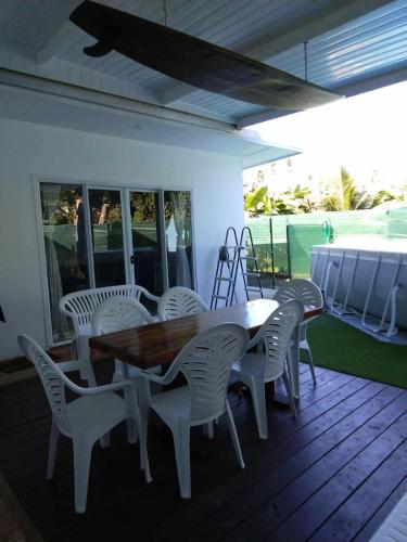 a wooden table and chairs on a deck at Fare Tehaikinoa Teahupo'o in Teahupoo