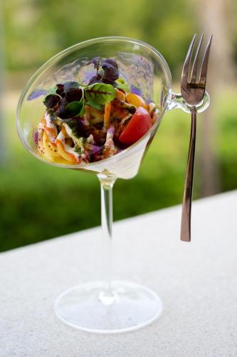 a salad in a wine glass with a fork at Villa Caribe Resort & Spa in Spigno Saturnia