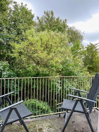 two chairs sitting in front of a fence at Seven Palms Villa in Rødby