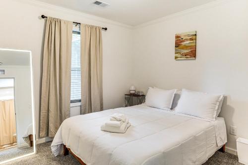 a bedroom with a large white bed with a window at Dog Friendly, Screened Porch St Stephen Retreat! in Saint Stephen
