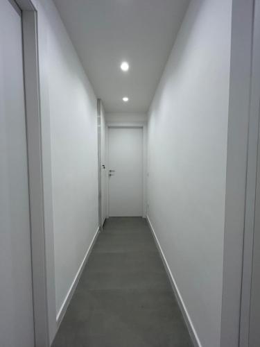 an empty hallway with white walls and a white ceiling at Dimore di Baia in Bacoli