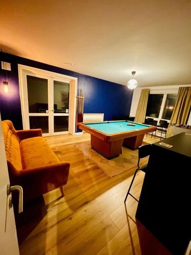 a living room with a pool table in it at Seven Palms Villa in Rødby