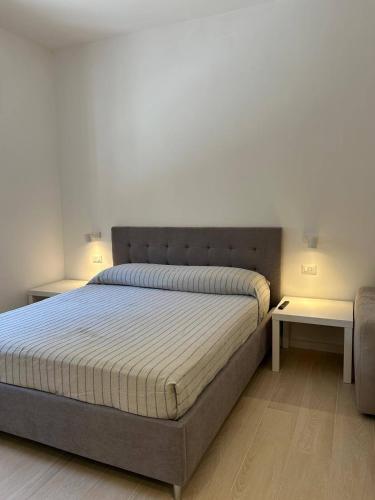 a bedroom with a large bed with two tables at Dimore di Baia in Bacoli
