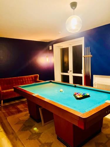 a room with a pool table and a couch at Seven Palms Villa in Rødby