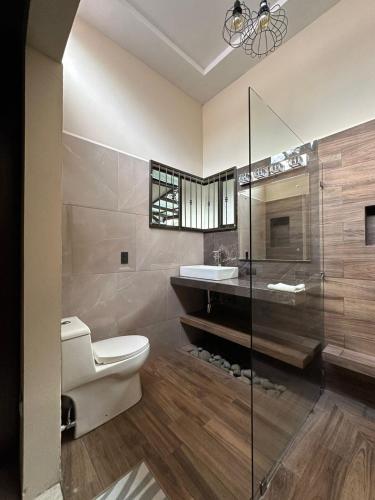 a bathroom with a toilet and a sink at Trébol House in Cuatro Esquinas