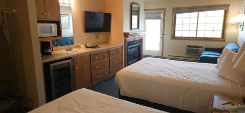 a hotel room with two beds and a sink at Homestead Suites - Fish Creek in Fish Creek