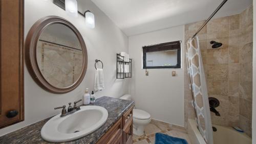a bathroom with a sink and a toilet and a mirror at Luxury Queen Room, Walk to UM, Free Car Service! in Miami