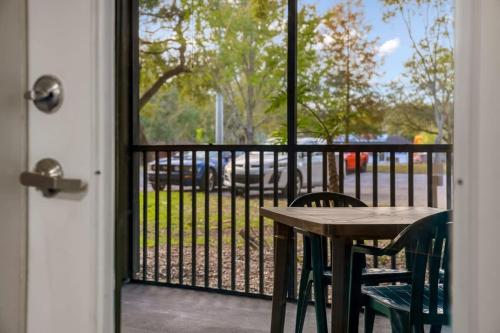 a porch with a table and chairs and a window at Pool Gym & Extended Stays Budget Frienly in Tampa