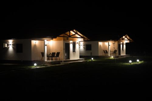 a house lit up at night with lights at Sunny Apartments in Malo Laole