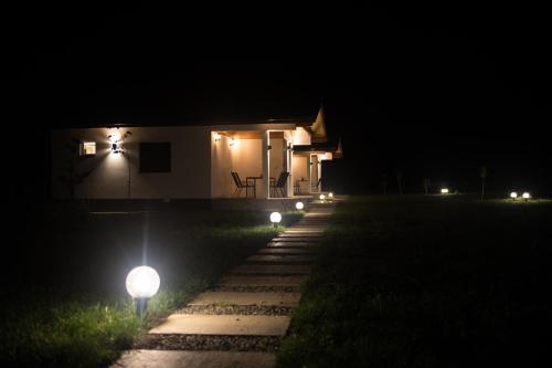a house at night with lights in front of it at Sunny Apartments in Malo Laole