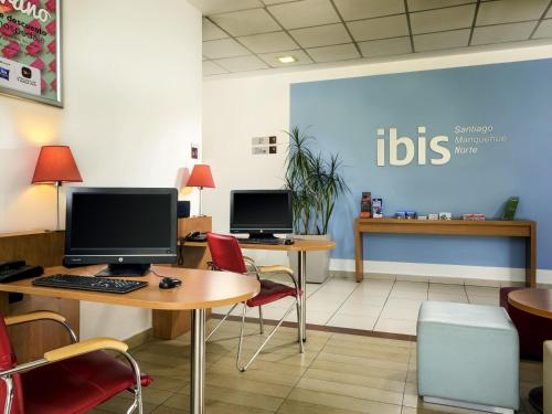 an office with two desks with computers on them at ibis Santiago Las Condes in Santiago