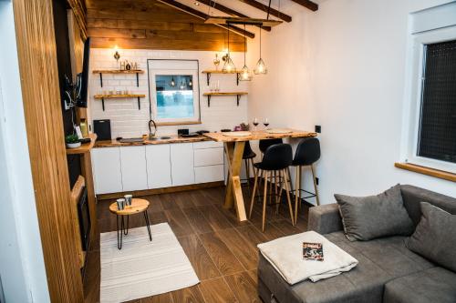 a living room with a couch and a small kitchen at Sunny Apartments in Malo Laole