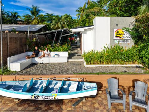 a boat sitting on a patio next to a house at Tortuguero7 lake view in Tortuguero