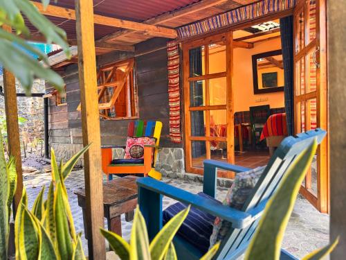 a porch of a house with chairs on it at La Iguana Perdida in Santa Cruz La Laguna