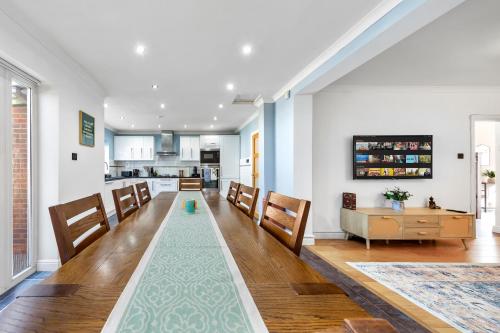 a living room with a long table and chairs at The Aviator Heathrow in Harmondsworth
