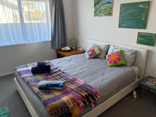 a bedroom with a bed with pillows on it at CareGreen BnB in Napier