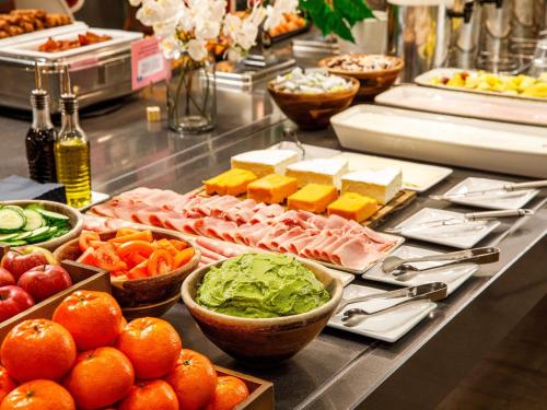 a buffet with different types of food on a table at ibis London Blackfriars in London