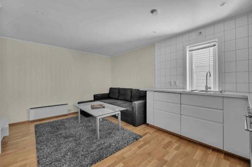 a living room with a couch and a table at Aurora View Retreat Beautiful Berg in Tromsø