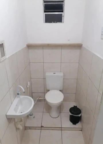 a bathroom with a toilet and a sink at Residencia 45 in Fortaleza
