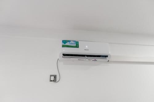 a computer monitor on a shelf with a cable at Transit Heaven - 10 Minutes to Airport in Katunayake