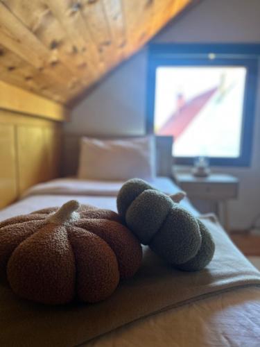 a teddy bear sitting on top of a bed at Vila Gorska in Žabljak