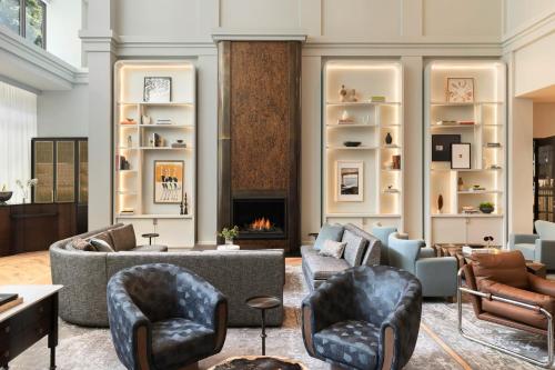 a living room with furniture and a fireplace at Kimpton Hotel Monaco Seattle by IHG in Seattle