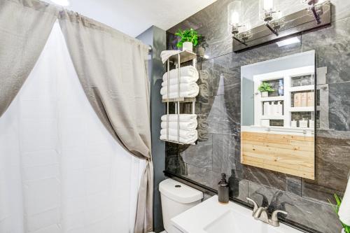 a bathroom with a sink and a toilet and a mirror at Walk to Campus and Riverfront Park Missoula Gem! in Community Medical Center Heliport