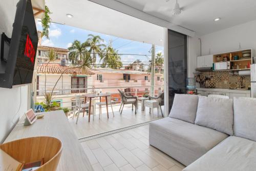 a living room with a couch and a table at Maravilla Suites - Bucerias Golden Zone in Bucerías