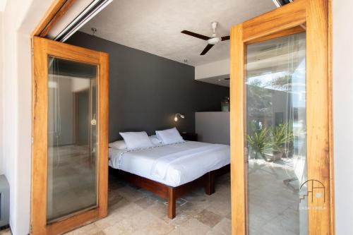 a bedroom with a bed and a mirror at Spectacular House with a Private Beach Front in Ixtapa-Zihuatanejo International