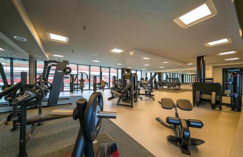 a gym with treadmills and ellipticals in a building at Aurora Luxe Apartment Växjö Near Vida Arena in Växjö