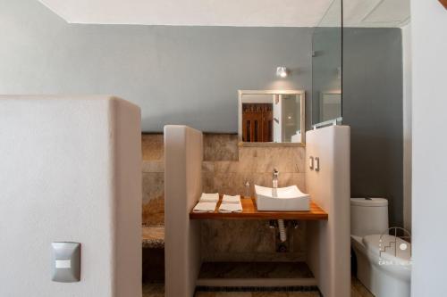 a bathroom with a sink and a mirror at Spectacular House with a Private Beach Front in Ixtapa-Zihuatanejo International