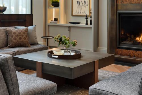a living room with a coffee table in front of a fireplace at Kimpton Hotel Monaco Seattle by IHG in Seattle