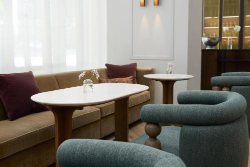 a living room with a couch and a table and chairs at Kimpton Hotel Monaco Seattle by IHG in Seattle