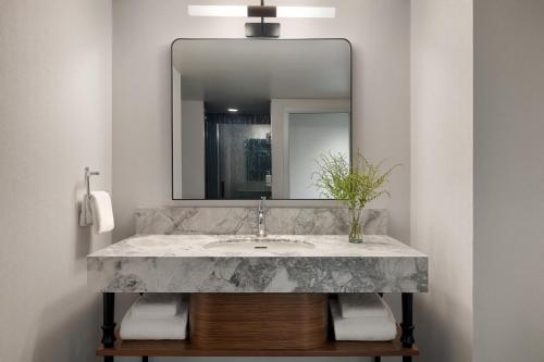 a bathroom with a sink and a mirror at Kimpton Hotel Monaco Seattle by IHG in Seattle