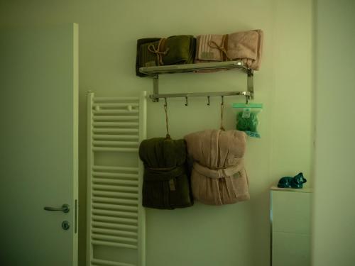 a room with bags hanging on a wall at L'introvabile in Cesena