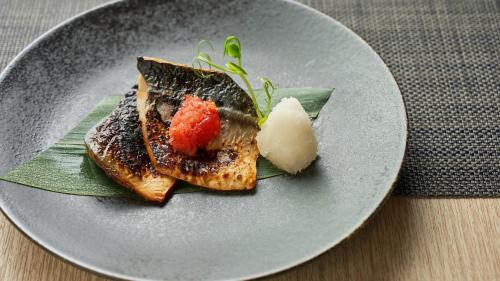 a plate with some food on a table at Mitsui Garden Hotel Kyoto Kawaramachi Jokyoji in Kyoto